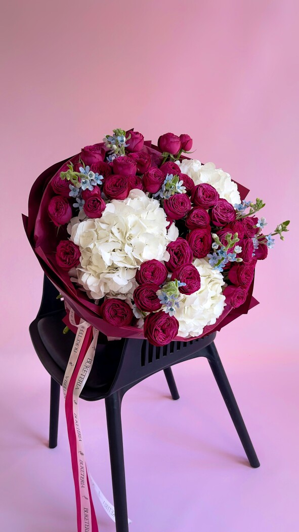 Burgundy spray roses with white hydrangeas and blue tweedia