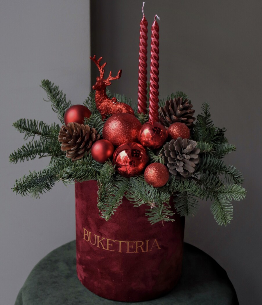 Decorative composition of festive red elements in a box