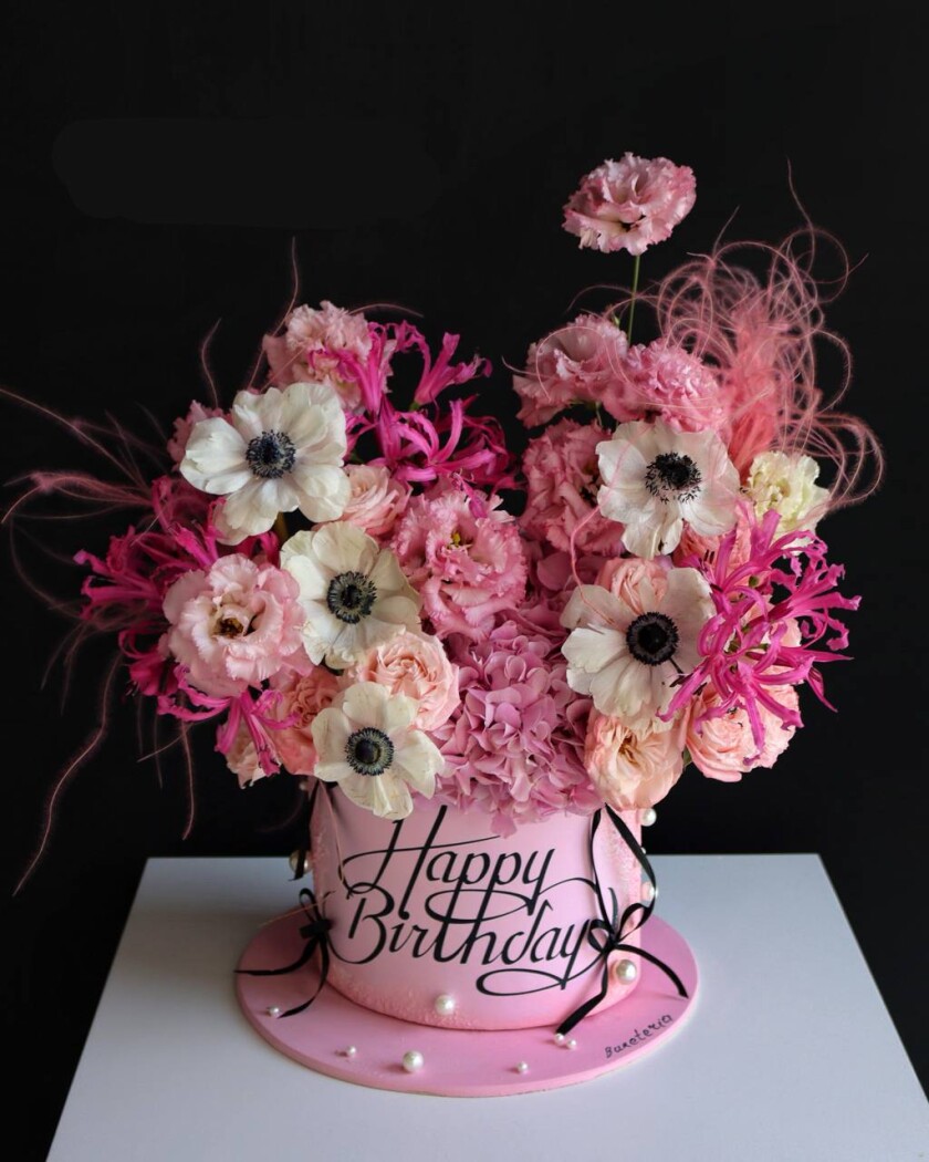 Decorative composition of hot pink nerines and white anemones in an art box