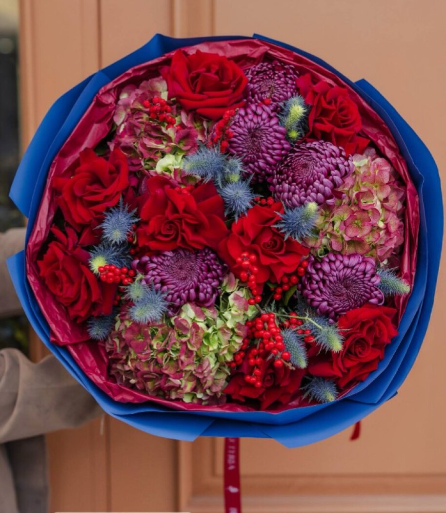 Mixed bouquet of red roses, green hydrangeas, and purple chrysanthemums