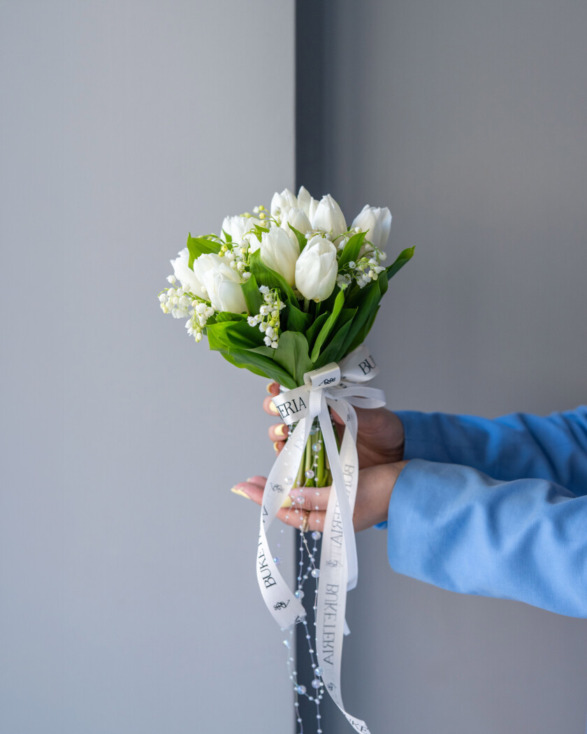 Eleven white tulips and ten lily of the valley
