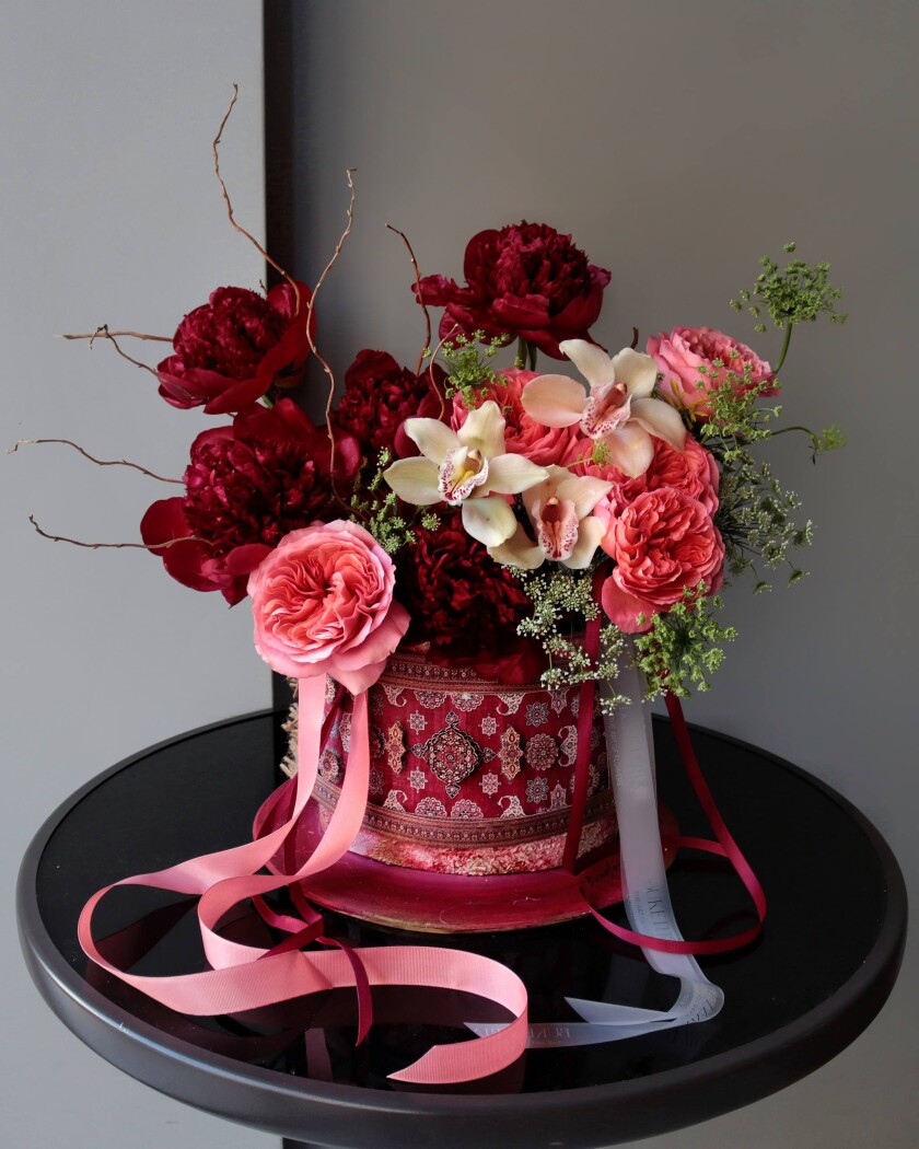 Decorative composition of burgundy peonies and dusty pink garden roses