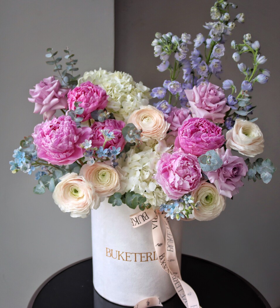 Decorative composition of pink peonies and cream ranunculus