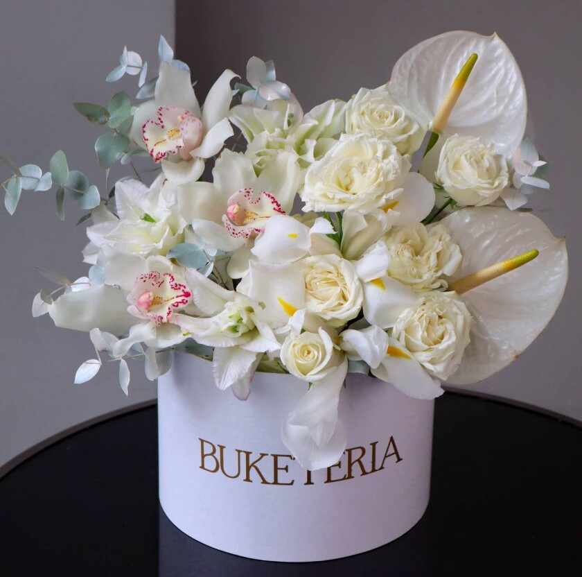 Elegant composition of white anthuriums and blush cymbidium orchids