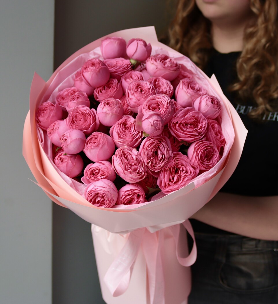 Nine hot pink spray roses in waterproof paper