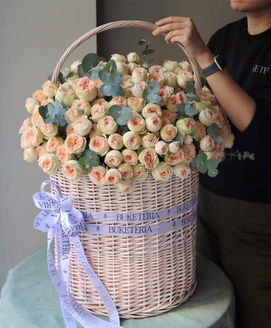 Peach spray roses in a rustic basket