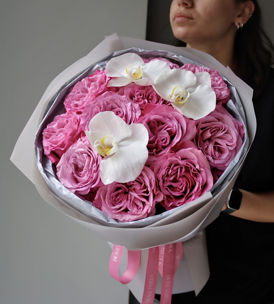 Eleven light pink garden roses and three white phalaenopsis orchids