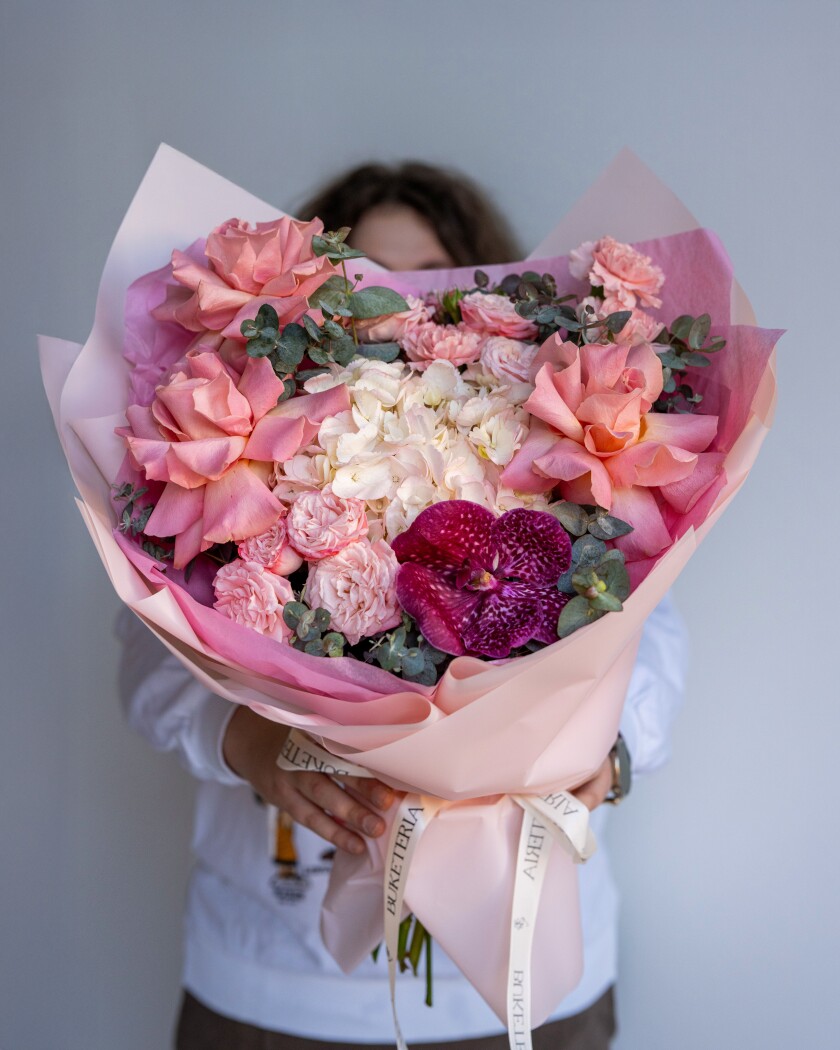 Three light pink garden roses and two peach spray roses