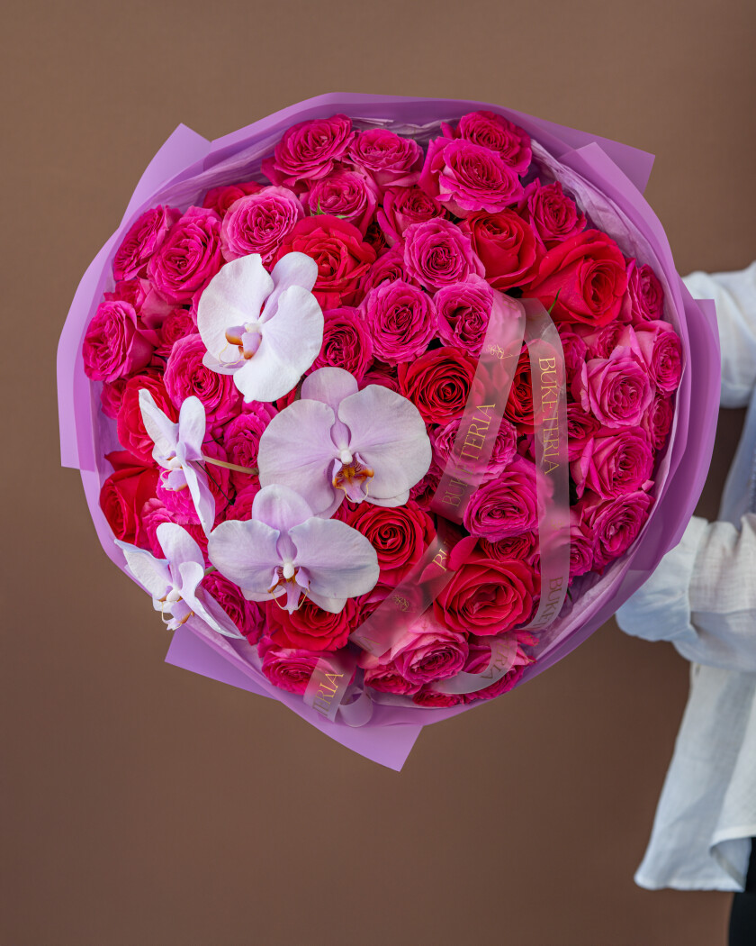 Fifteen hot pink garden roses with pink spray roses and white orchids