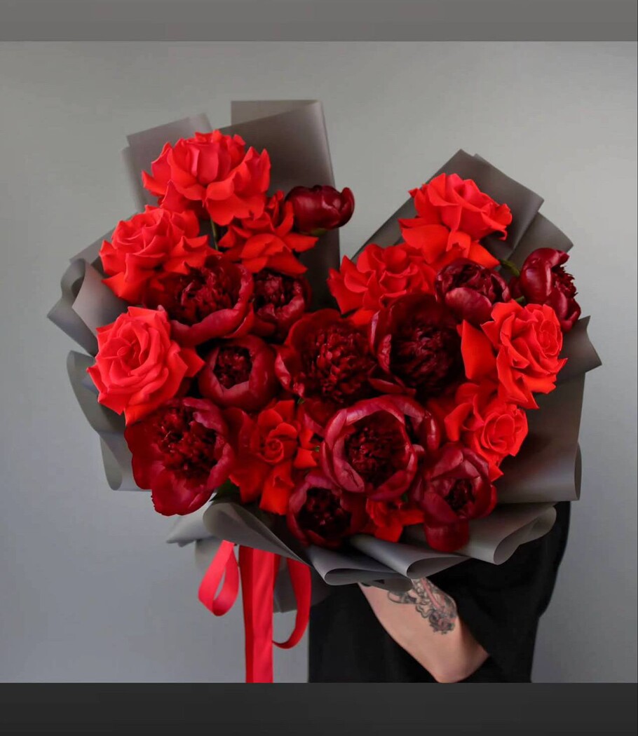 Burgundy peonies and red hybrid tea roses