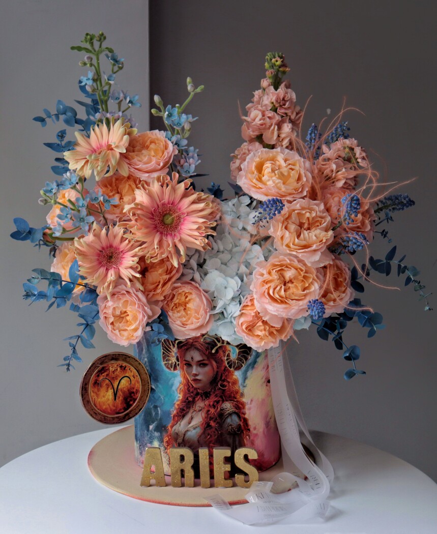 Decorative composition of apricot spray roses and light blue tweedia