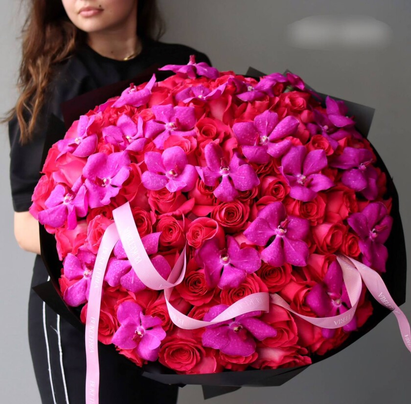 Mixed bouquet of red garden roses and hot pink vanda orchids