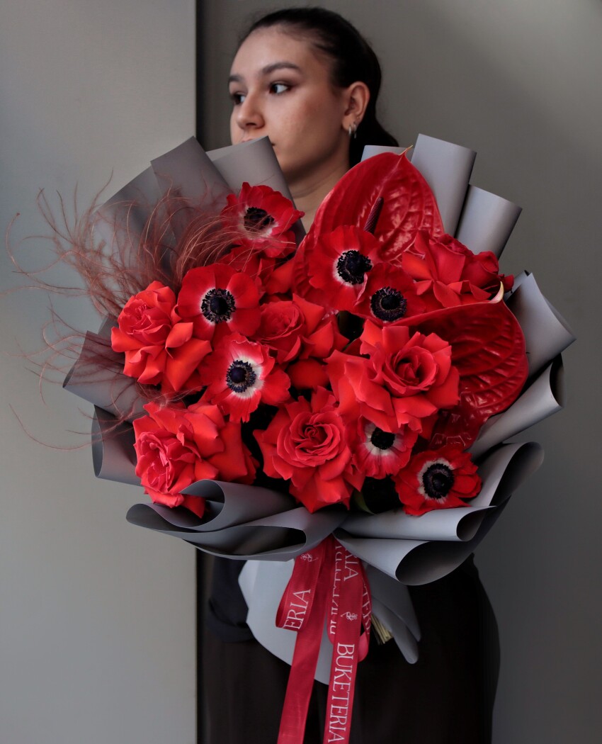 Red anemones with coral hybrid tea roses and red anthuriums