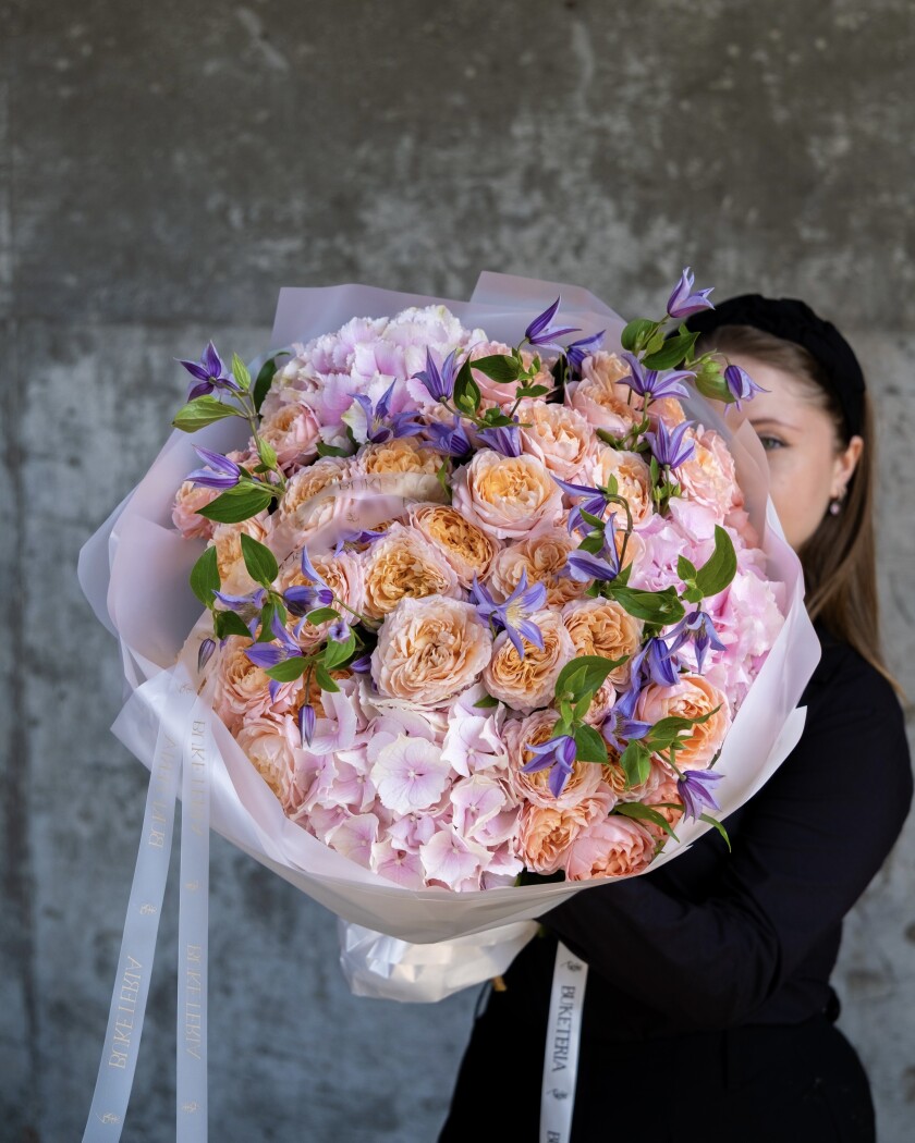 Peach spray roses with lavender clematis and pink hydrangea