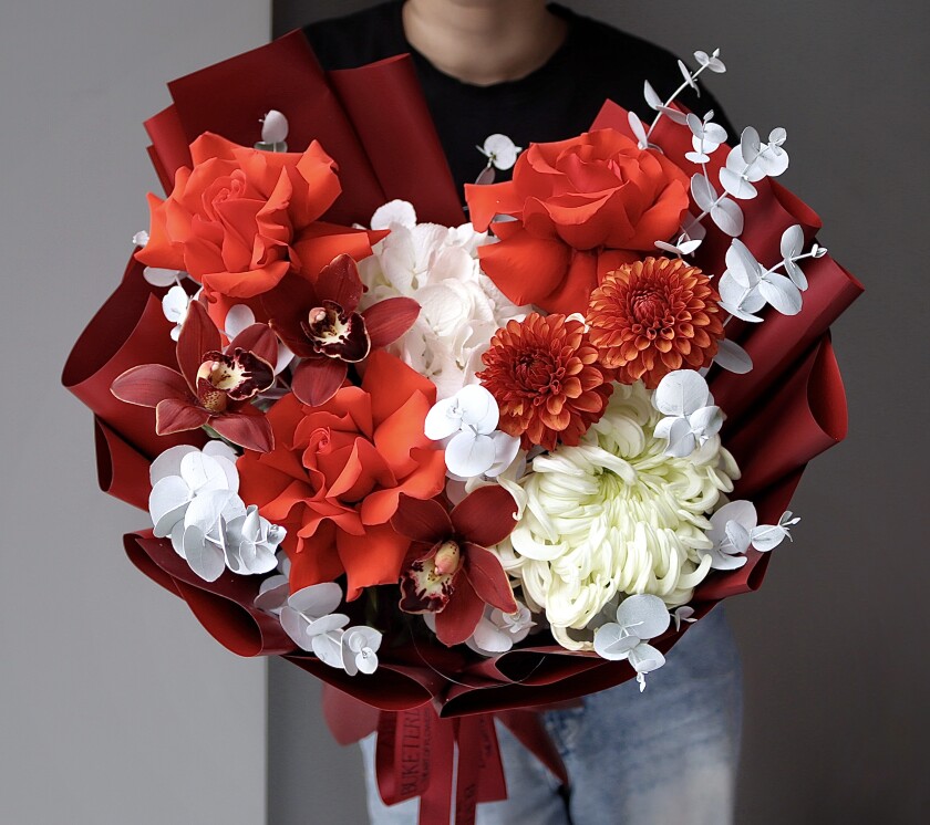 Red roses with orange dahlias and white hydrangea