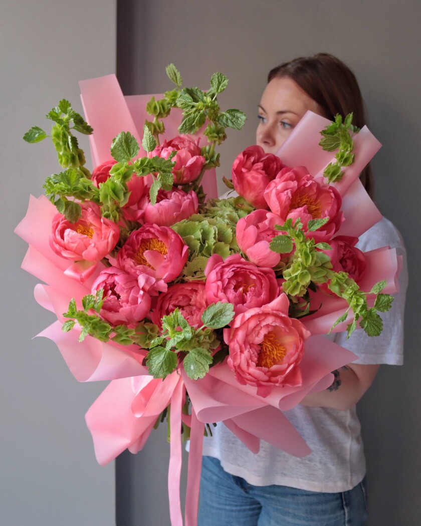 Thirteen coral peonies and one green hydrangea