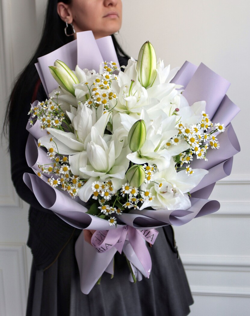 Three white oriental lilies in waterproof paper
