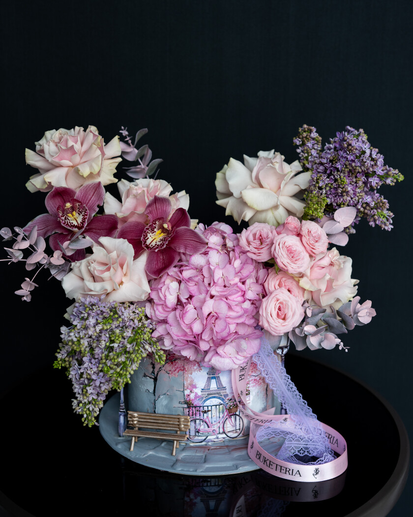 Decorative composition of purple lilacs and cream garden roses