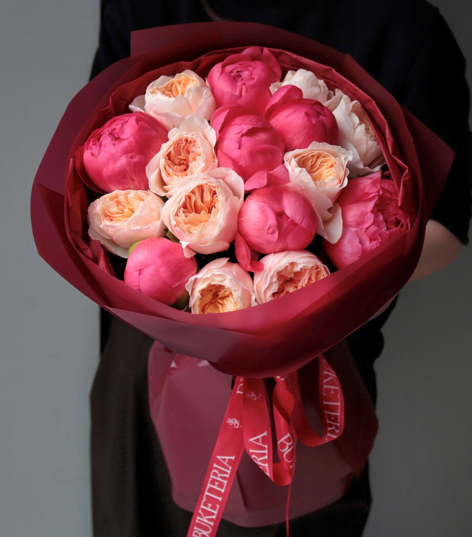 Seven pink peonies and four peach spray roses