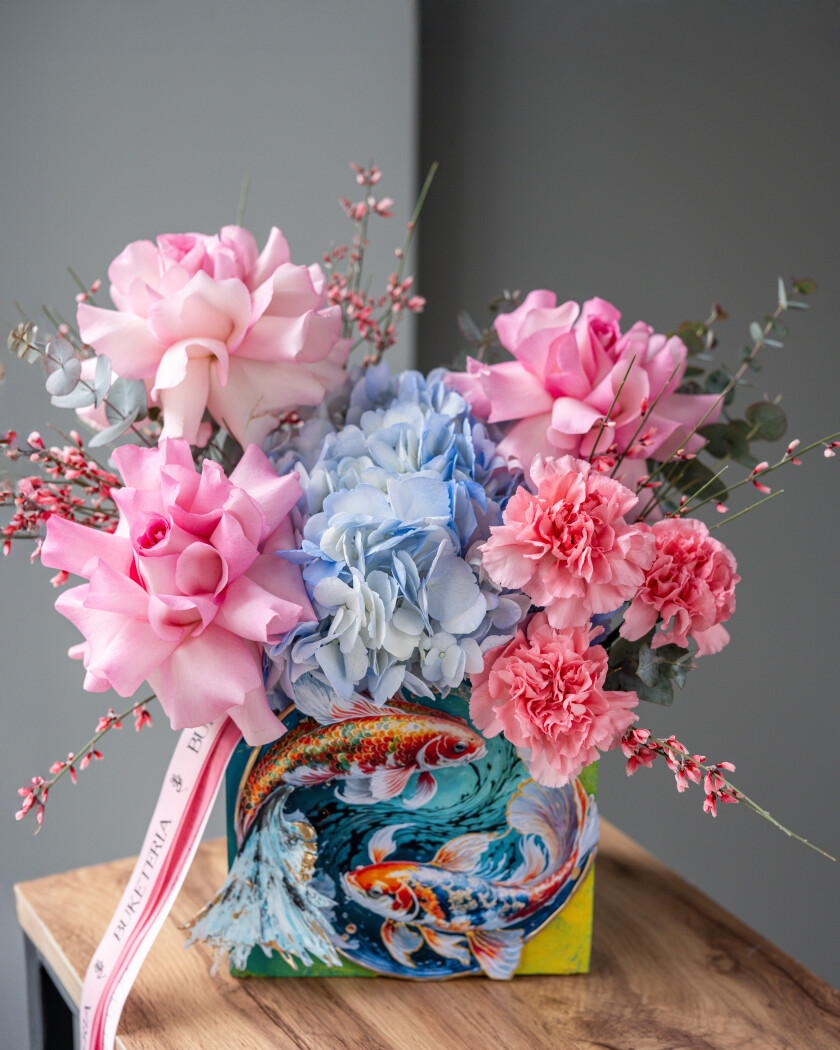 Decorative composition of light pink garden roses and light blue hydrangea