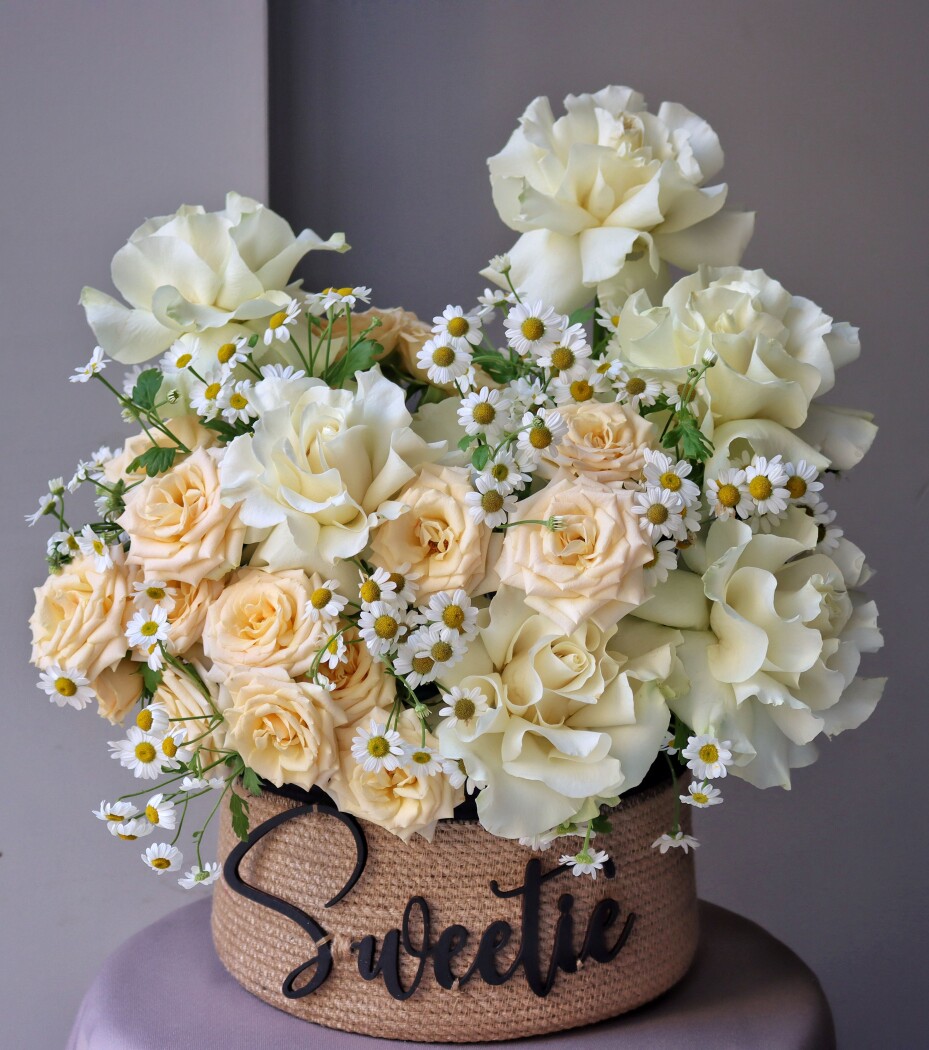 Peach roses with cream garden roses in a pot