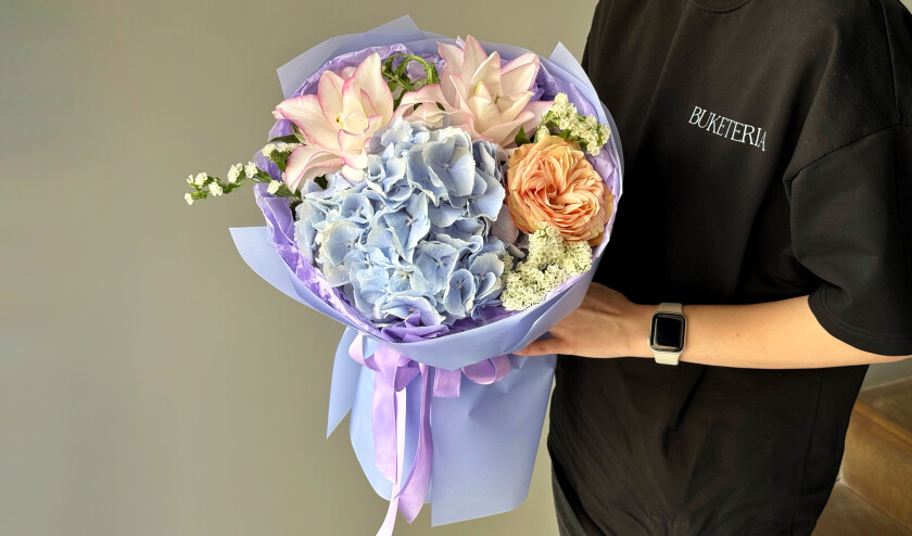 Mixed bouquet of blue hydrangea, peach garden rose, and pink oriental lily