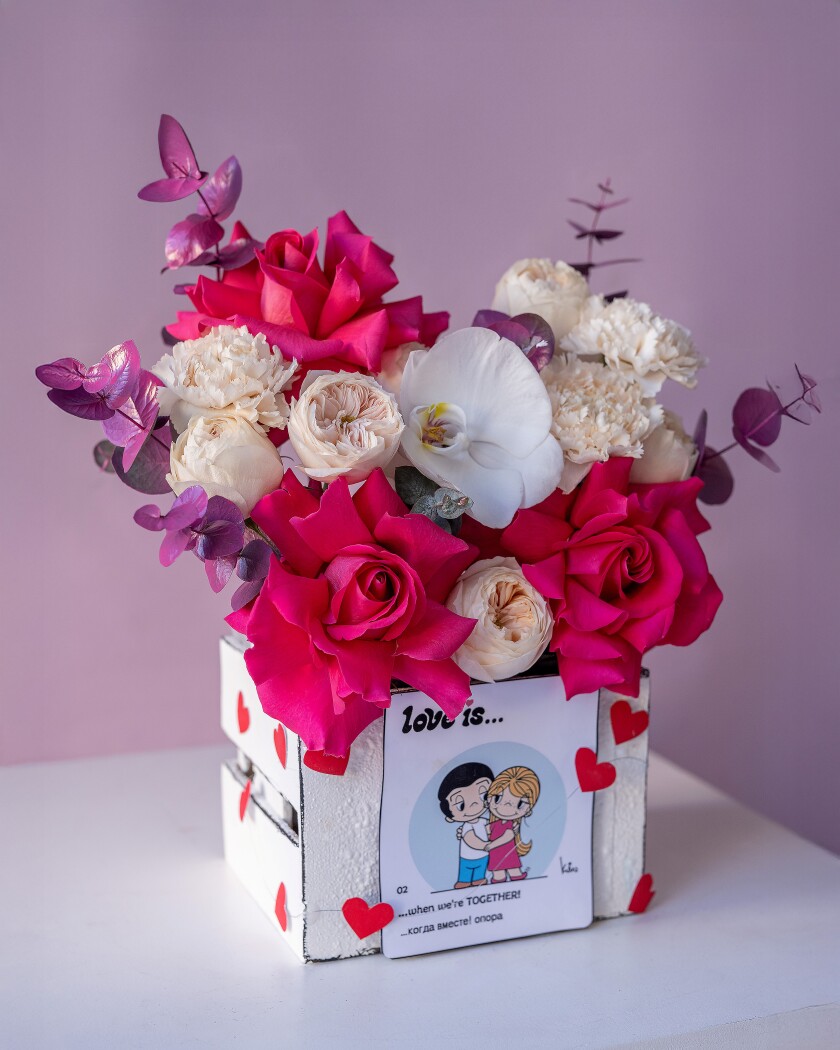 Decorative composition of peach garden roses and hot pink spray roses