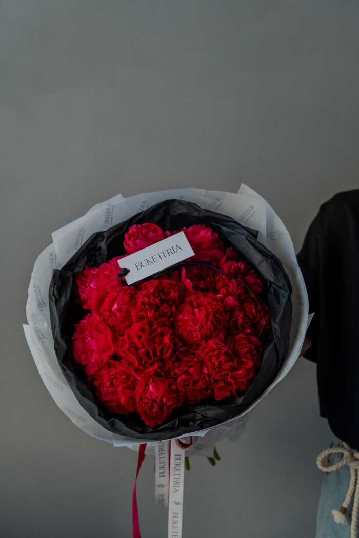 Twenty-seven red peonies in waterproof paper