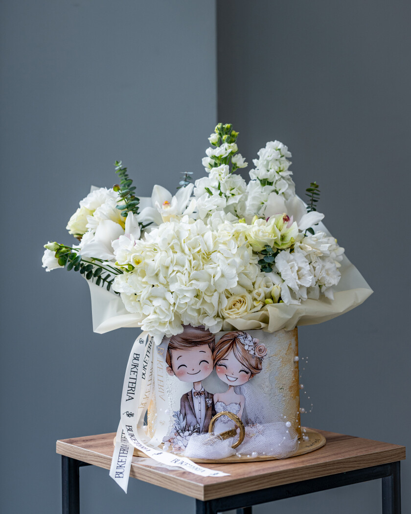 Decorative composition of white hydrangeas and cymbidium orchids