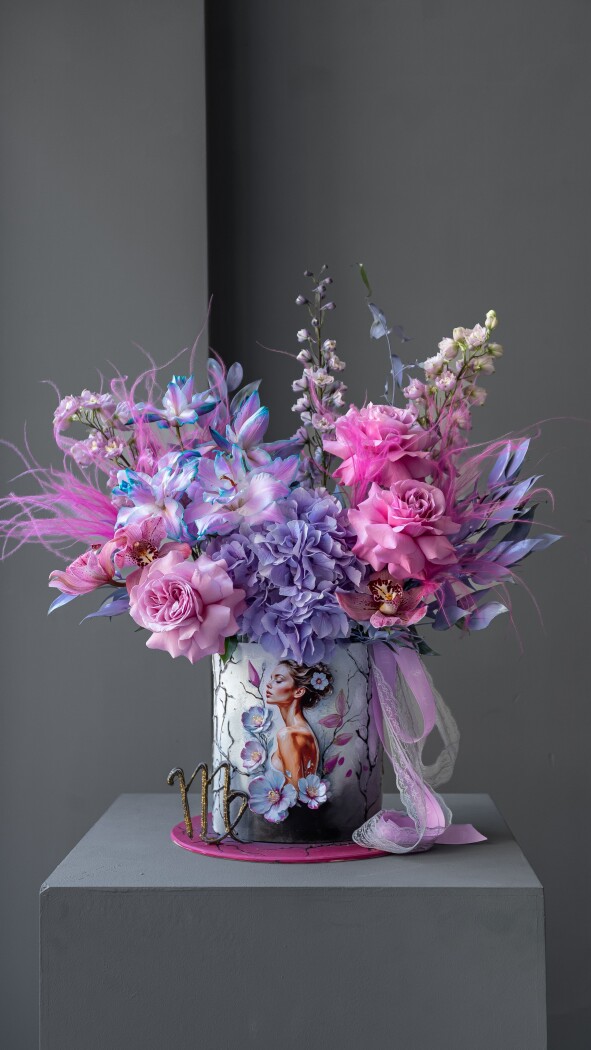 Decorative composition of light blue delphiniums and blush garden roses