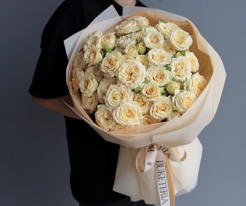 Nine light yellow spray roses in waterproof paper