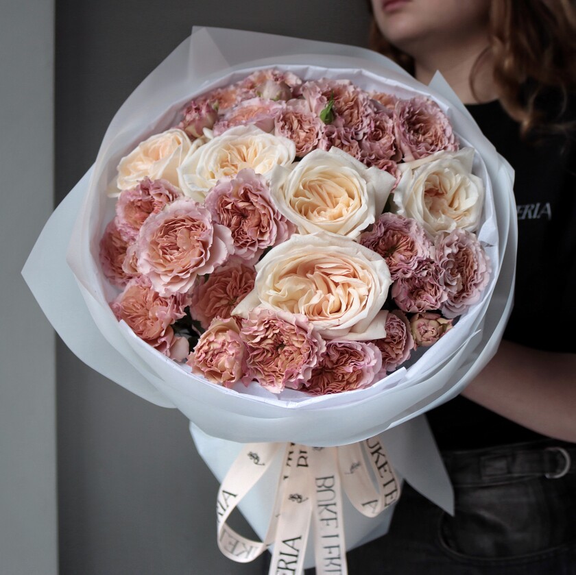 Seven dusty pink spray roses and five cream garden roses