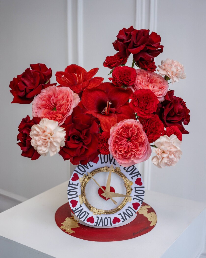 Five burgundy hybrid tea roses with peach garden roses
