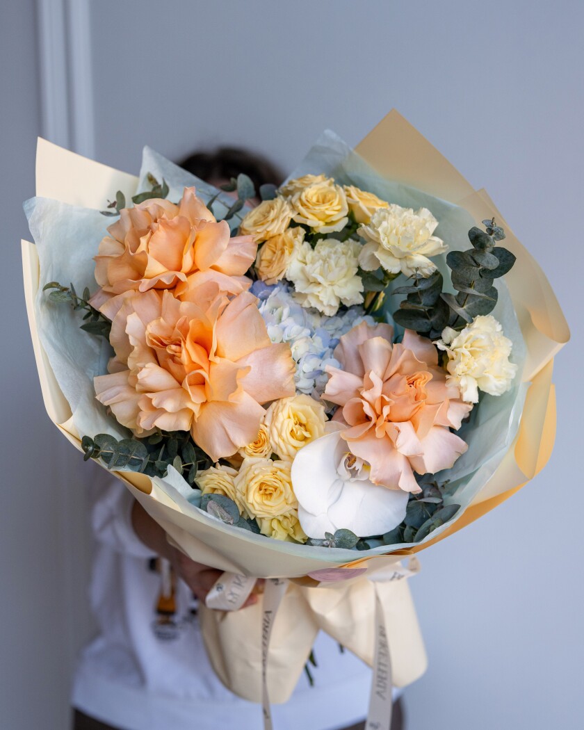 Peach garden roses with yellow spray roses and light blue hydrangea