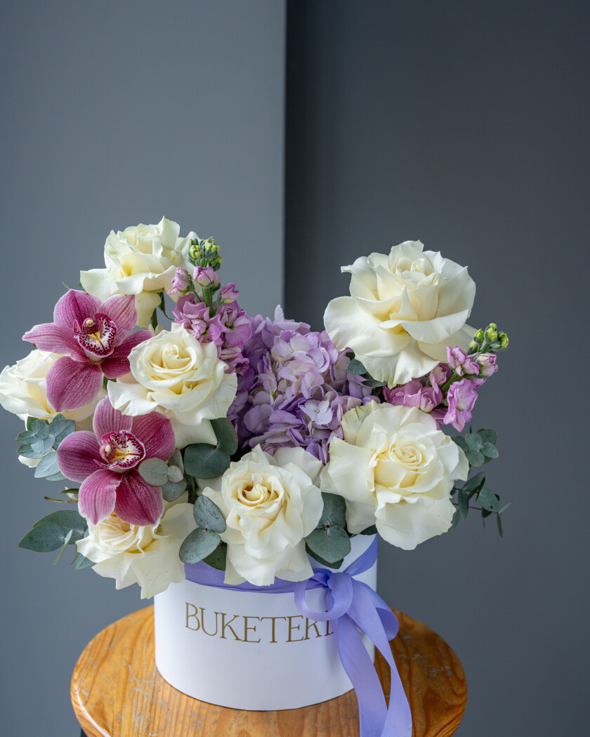 Seven cream garden roses with lavender hydrangea and burgundy cymbidium orchids