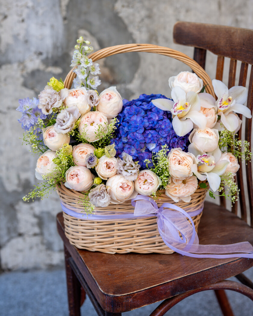Serene composition of peach spray roses and blue hydrangeas