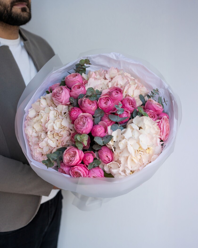 Six hot pink spray roses and three cream hydrangeas