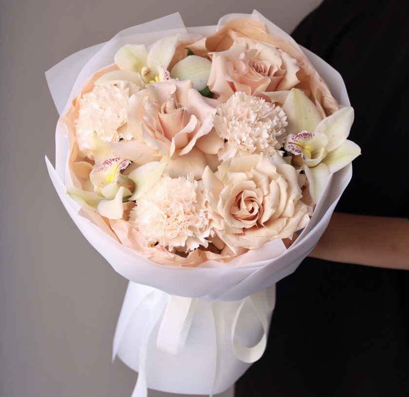 Blush garden roses with cream cymbidium orchids and peach carnations