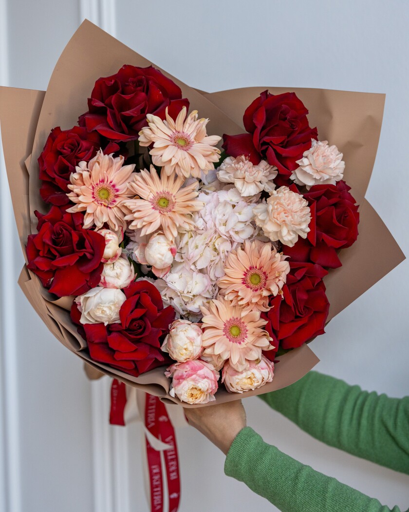 Seven red hybrid tea roses with peach gerberas and white hydrangea