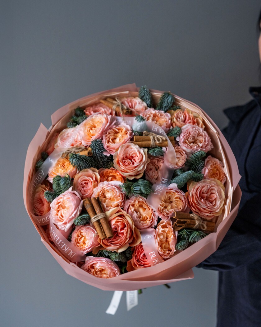 Peach garden roses with noble fir and cinnamon stick