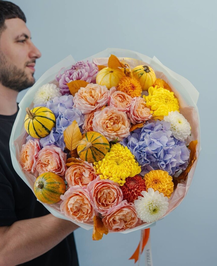 Cheerful bouquet of yellow dahlias and peach spray roses