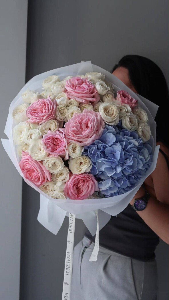 Twelve blush spray roses with light pink garden roses and blue hydrangea