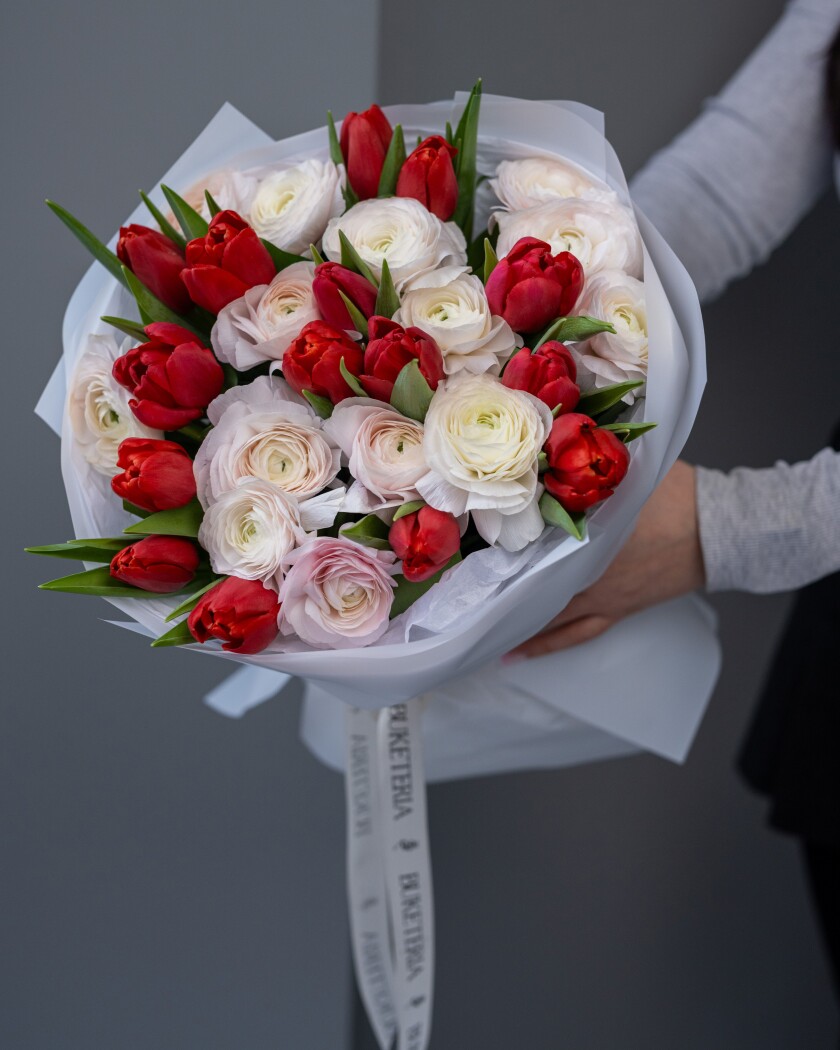 Fifteen light pink ranunculus and red tulips