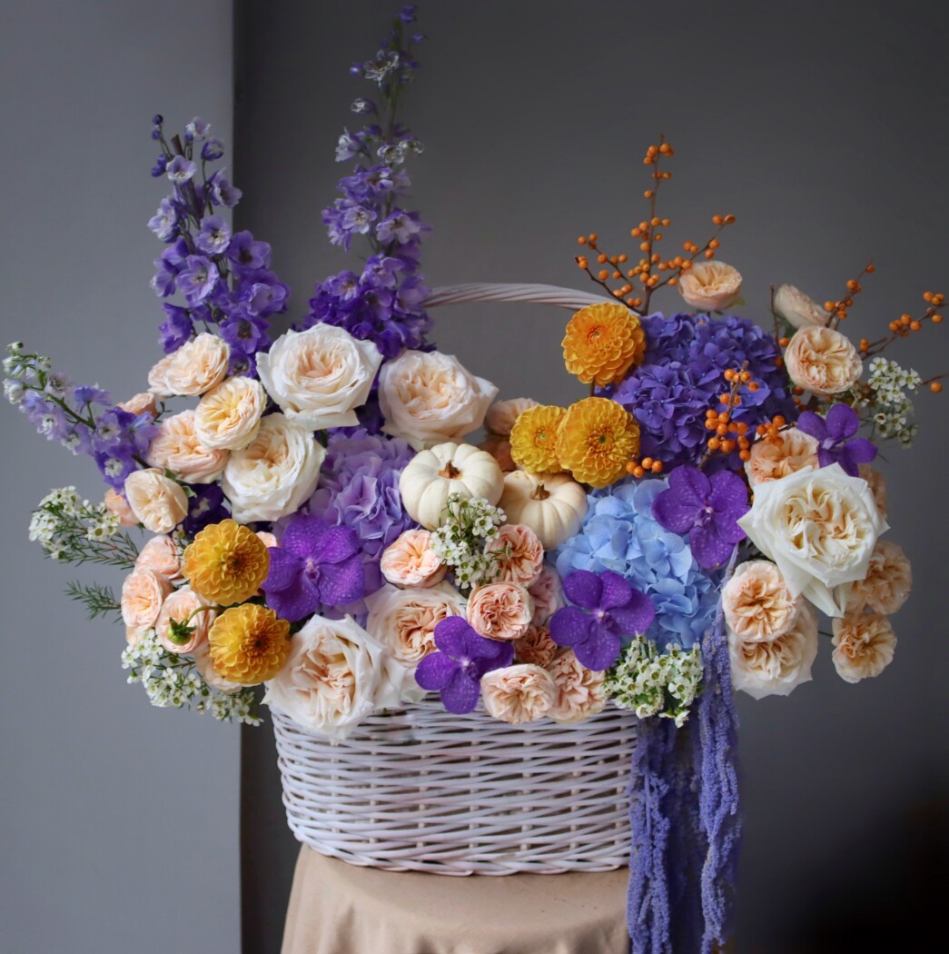Lilac hydrangeas with peach garden roses and purple orchids