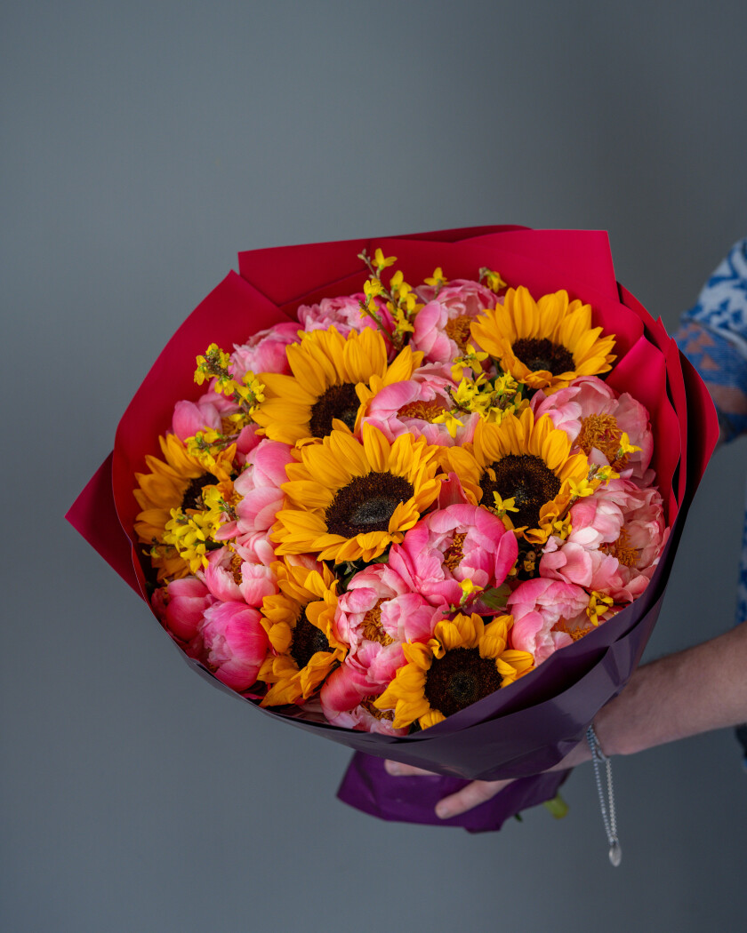 Pink peonies with yellow sunflowers
