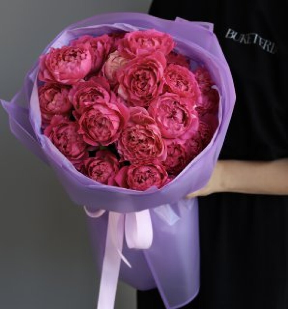 Six hot pink spray roses in waterproof paper