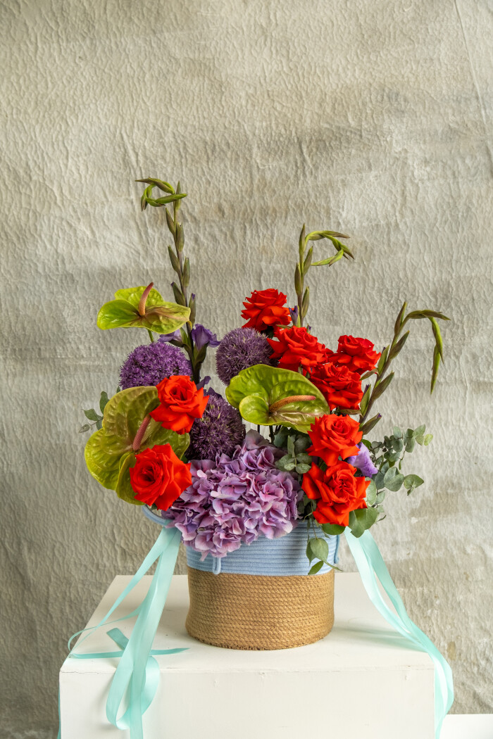 Red roses with green anthuriums and purple alliums
