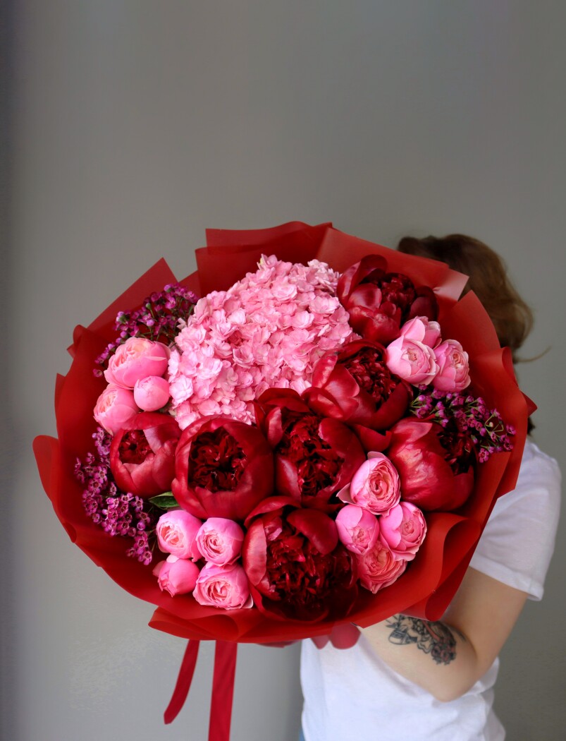 Burgundy peonies with light pink hydrangea and pink spray roses