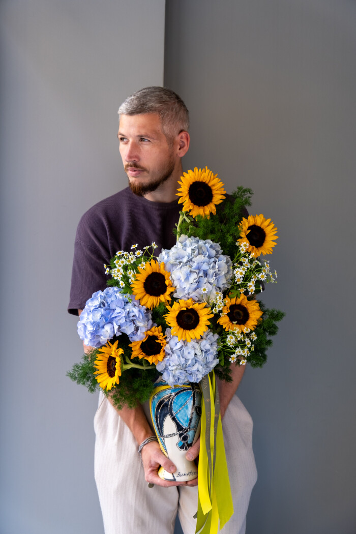 Decorative arrangement of yellow sunflowers and blue hydrangeas
