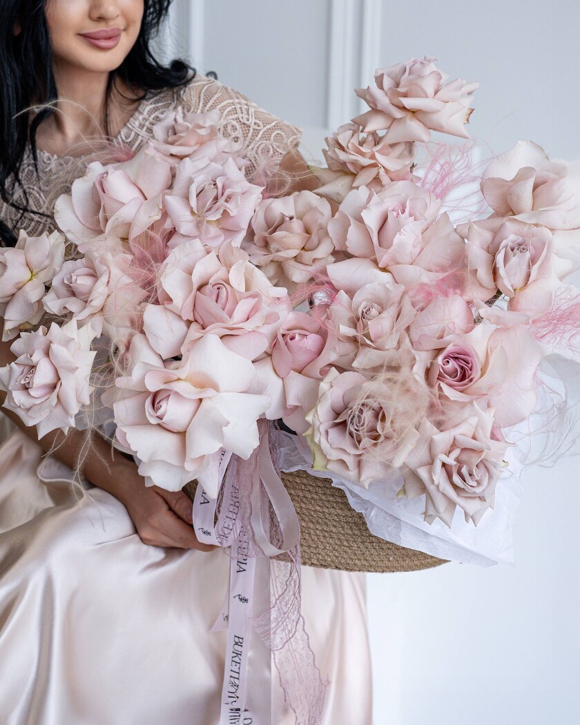 Blush garden roses with feather grass in a pot